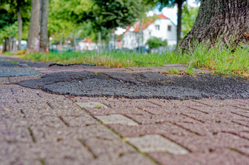 Poorly repaired bicycle lane with a bumpy edge in Berlin, Germany.