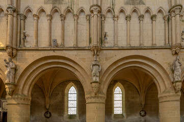 Obraz premium Langrune-Sur-Mer, France - 07 18 2023: View of the ceiling and stone statues inside the St. Martin's Church.