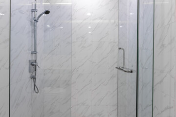 stainless steel shower in the bathroom  Bathroom with white marble tiles in the hotel