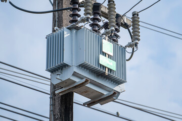 Electrical transformer on a power pole in Thailand, voltage