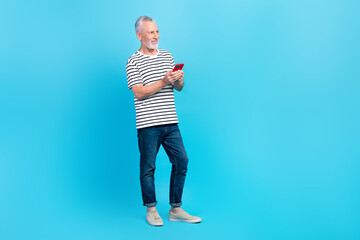 Full length photo of positive retired man wear stylish striped clothes look empty spae sale device...