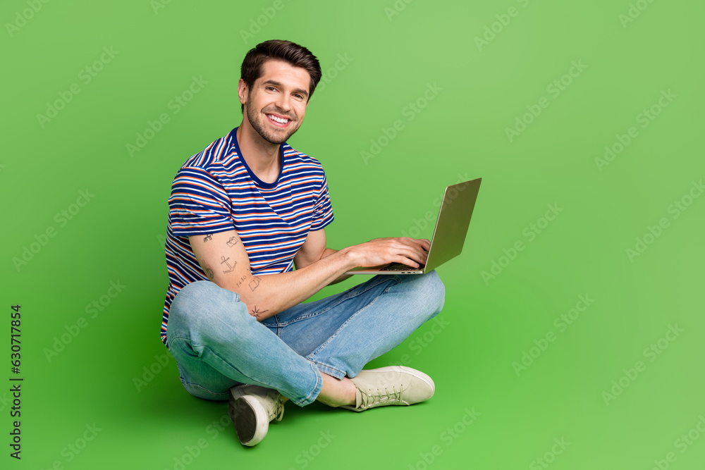 Aufkleber full length photo of charming cheerful guy wear striped t-shirt texting modern device empty space is