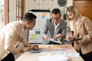 Asian businessmen, women and men Talk about new projects, presents at home office.
