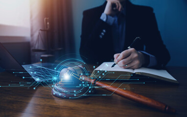 Justice and law concept.Male judge in a courtroom with the gavel, working with, computer and...
