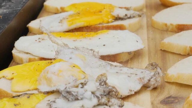 Delicious Fried Eggs Fresh from the Griddle Served on White Bread