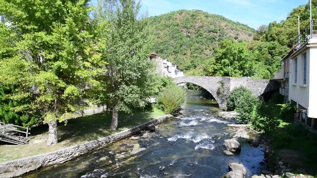 Aude river with the water flowing with freshness, cascading over a bed of stones. Axat, Aude, France, Europe