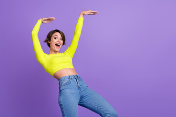 Portrait of carefree gorgeous slender person enjoy clubbing dancing empty space ad isolated on purple color background