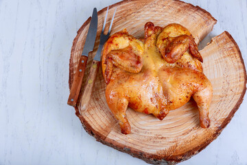 Homemade whole grilled BBQ roasted chicken on a wooden board was impressive.
