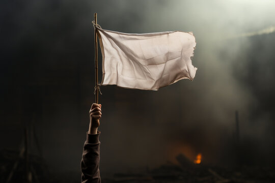 Arm holding stick with a worn white flag in fog on dark background. Soldier in trench with barbed wire surrendering, loosing in war battle, win loose concept. Generative AI Technology
