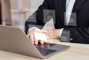 Document Management System (DMS) working Businessperson on a laptop with a virtual screen. Process automation to efficiently manage files.Software for archiving, searching, and managing corporate file