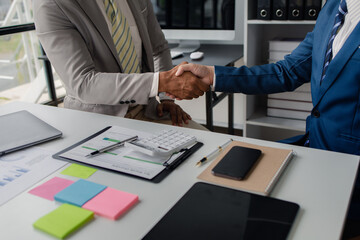 Two business men shake hands, Two businessmen are agreeing on business together and shaking hands after a successful negotiation. Handshaking is a Western greeting or congratulation.