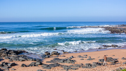 Surfers Surfing Ocean Waves Rocky Bay Cove Horizon Blue Landscape.