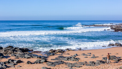 Surfers Surfing Ocean Waves Rocky Bay Cove Horizon Blue Landscape.