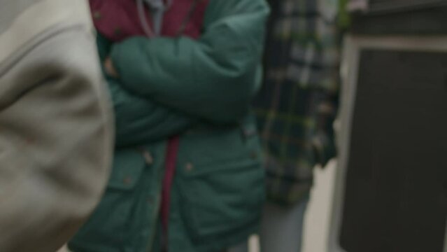 Cropped shot of hands of volunteer giving essentials in transparent packaging to people in need in slow motion