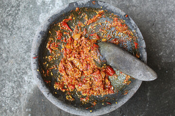 Sambal is an Indonesian chilli sauce or paste, made from red chili pepper and onion, mashed by...