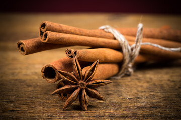 Close up of cinnamon sticks and star anise on wood