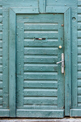 Medieval textured wooden door on the street of a European city