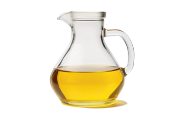 A glass jug containing vegetable oil set apart on a white background.