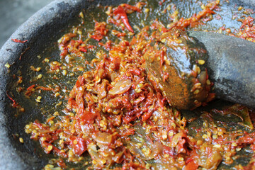 Sambal is an Indonesian chilli sauce or paste, made from red chili pepper and onion, mashed by stone mortar and pestle.