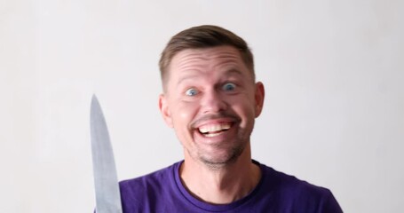 Crazy man looking at camera and waving knife 4k movie. Mental disorder manic personality disorder concept
