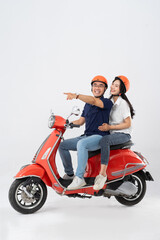 Fototapeta na wymiar image of asian couple riding scooter on white background