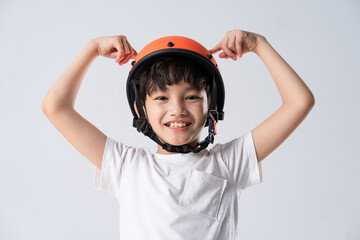 portrait of asian boy wearing orange helmet on white background