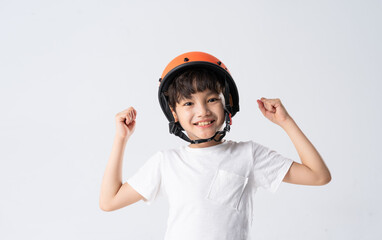 portrait of asian boy wearing orange helmet on white background