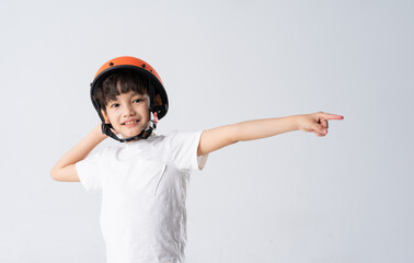 portrait of asian boy wearing orange helmet on white background