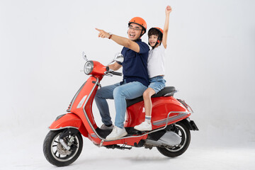 father and son wearing helmets and riding motorbikes