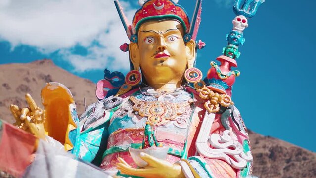 Closeup shot of statue of Guru Padmasambhava besides the Sani Lake near the Sani Monastery in Sani village near Padum in Zanskar, Ladakh, India. Statue besides the holy lake and in front of mountains	
