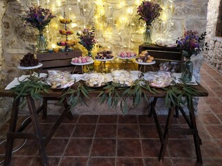 table decorated with plates of desserts, cups and candles