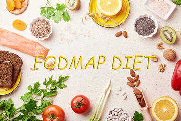 FODMAP healthy diet with text in center. Mediterranean low ingredients - vegetables, fruits, nuts, greens, beans, egg, flax seeds, chia seeds. Flat lay
