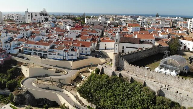 Sines city beach, Portugal. curved road. Aerial drone view. Flying over. High quality 4k footage
