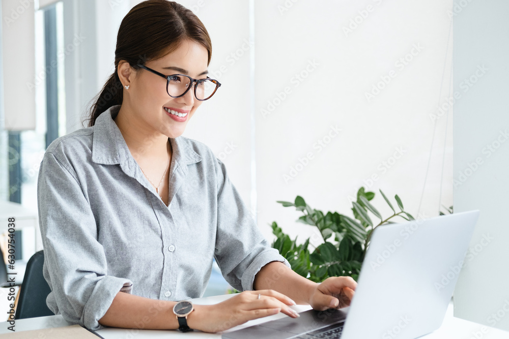 Canvas Prints cheerful business lady working on laptop in office, asian happy beautiful businesswoman in formal su