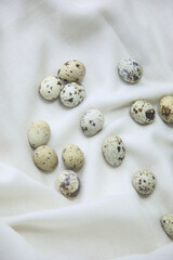 Obraz na płótnie Canvas Quail Eggs On A White Cloth 
