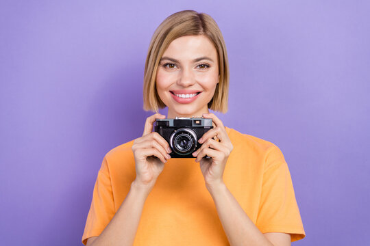 Portrait of friendly young lady hold retro old nostalgia photo camera professional filming your wedding isolated on violet color background