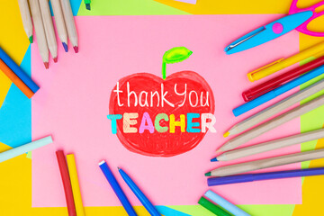 Childish lettering for Teachers' Day. Appreciation of teachers top view flat lay concept. Colored paper, multi-coloured letters, supplies