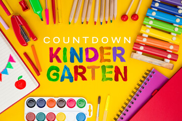 Countdown kindergarten background. Top view flat lay concept. Childish lettering, colored paper, supplies, stationery for Pre-school, nursery school, kindergarten or preschool educational