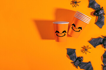 Halloween party background with Paper cup with Jack lantern face decoration. Disposable cup made of...