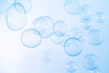 Beautiful Transparent Blue Soap Bubbles Floating in The Air. White Space, Abstract Fun Background, Blue Gradient Blurred Background, Refreshing of Soap Suds Bubbles Water.