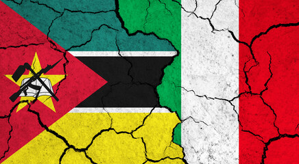 Flags of Mozambique and Italy on cracked surface - politics, relationship concept