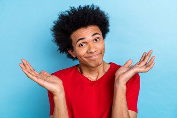 Photo of confused funny guilty guy with afro hairstyle dressed red stylish t-shirt shrugging...