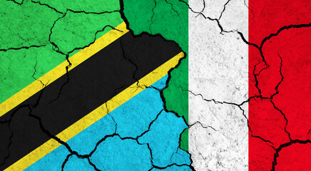 Flags of Tanzania and Italy on cracked surface - politics, relationship concept