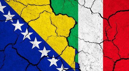 Flags of Bosnia and Italy on cracked surface - politics, relationship concept