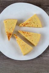 Portions of potato omelette on a white plate