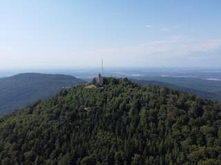 Aerial wide shot of the Merkur mountain and the Merkurturm radio tower in the Black Forest by Baden Baden, Germany