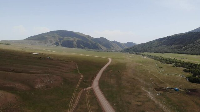 Semenovskoye Grigorevskoye Canyon mountains and green valley Kyrgystan near Issyk Kul. Aerial drone view. Flying over. High quality photo