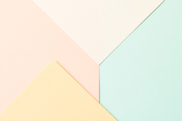 Rough kraft paper pieces collage background, geometric paper texture pastel colors. Mockup with copy space for text.