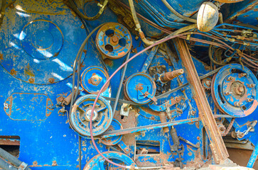 Belt drives of an old broken engine in agricultural combine