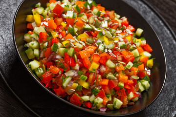 Israeli salad of finely diced veggies in bowl